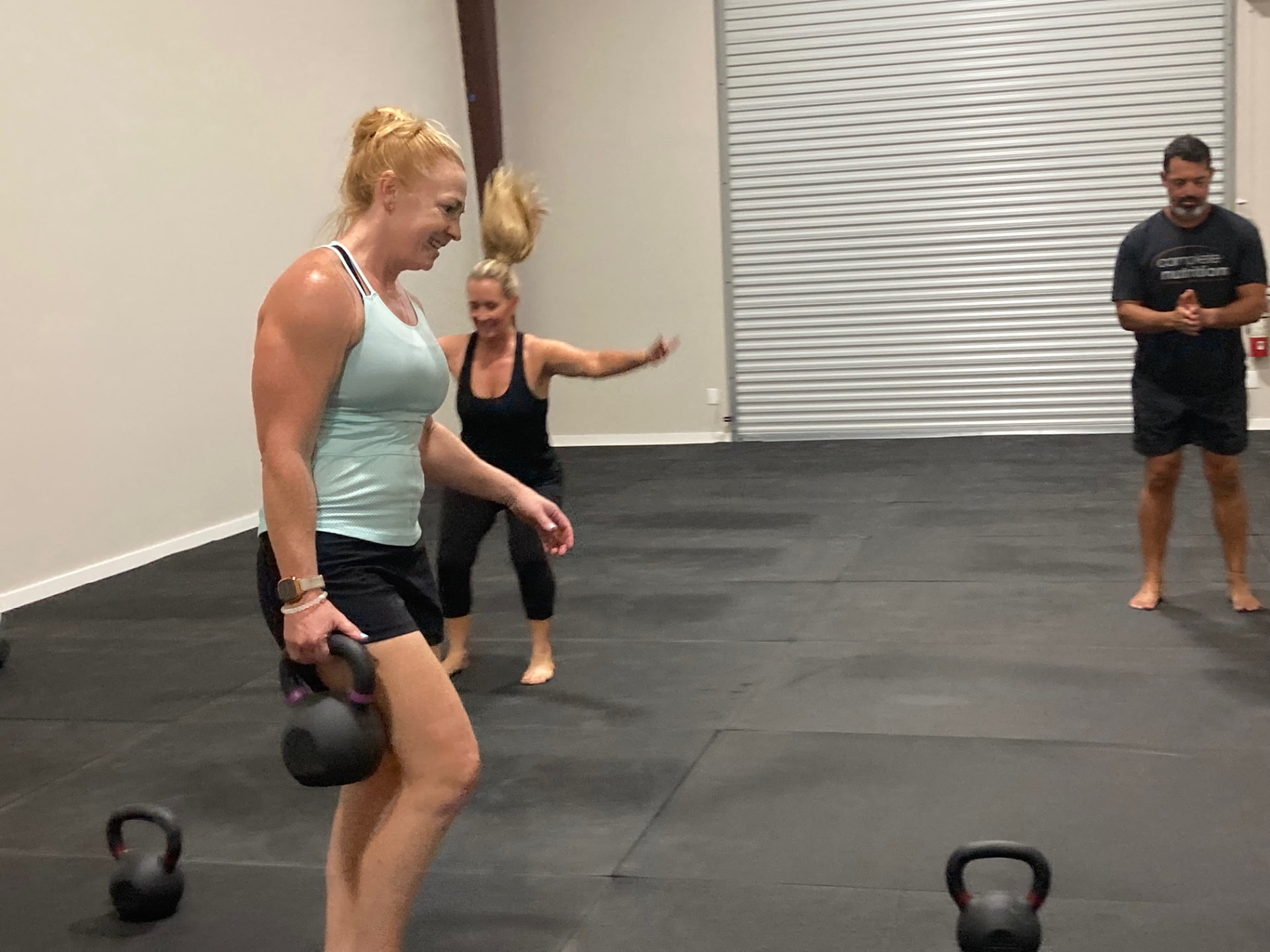 Member carrying a kettlebell during a semi-private class in Leander, TX