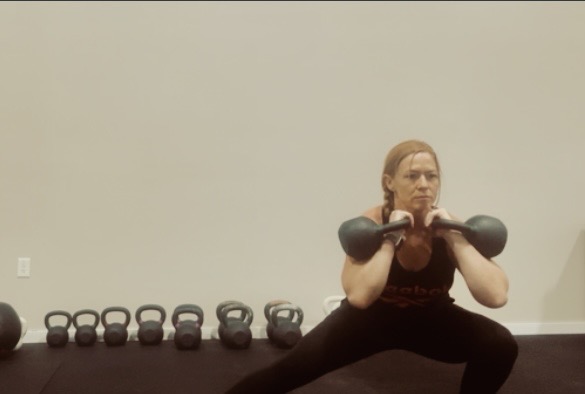 Double kettlebell front squat in the rack position