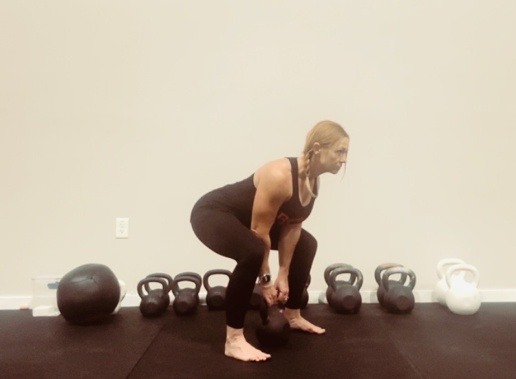Setting up the hinge before a kettlebell swing at Liberty Bells